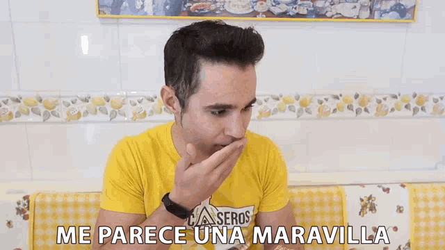 a man wearing a yellow t-shirt that says caseros on it