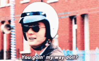 a man wearing a helmet and sunglasses is saying " you goin ' my way doll "