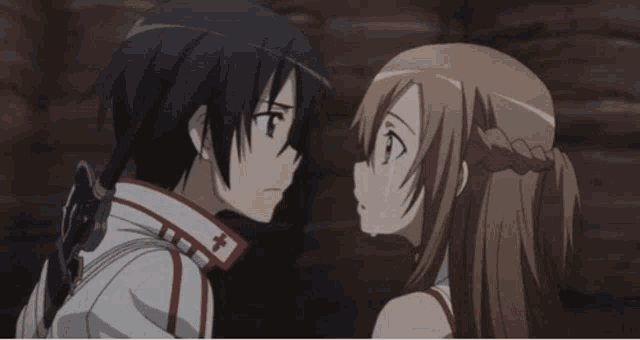 a man and a woman are kissing with a cross on their collar