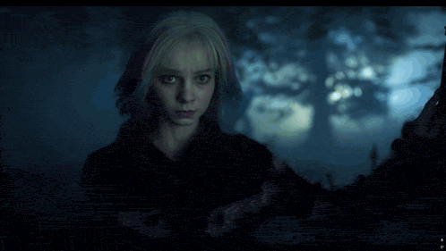 a girl with pigtails and a white collar is standing in the dark