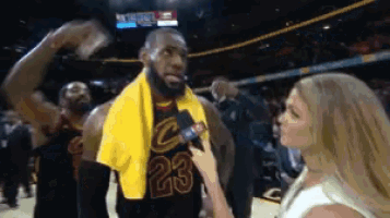 a basketball player with the number 23 on his jersey is being interviewed