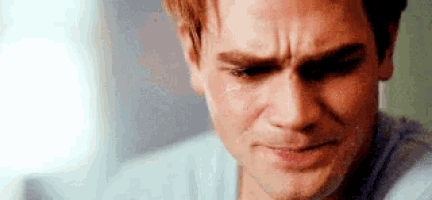 a close up of a man 's face with tears running down his face .