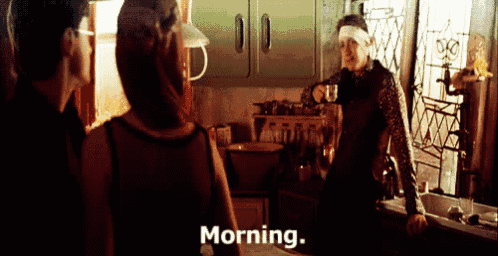 a woman is standing in a kitchen talking to a man who is pouring a cup of coffee and the word morning is on the bottom