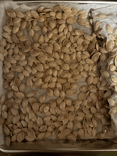 a tray of pumpkin seeds sitting on a table