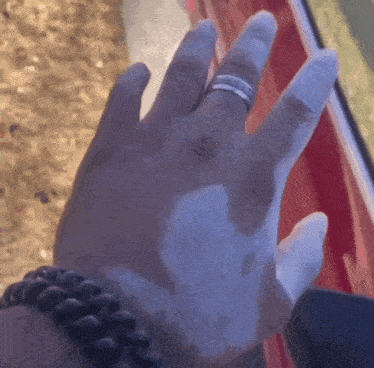 a close up of a person 's hand with a silver ring on it