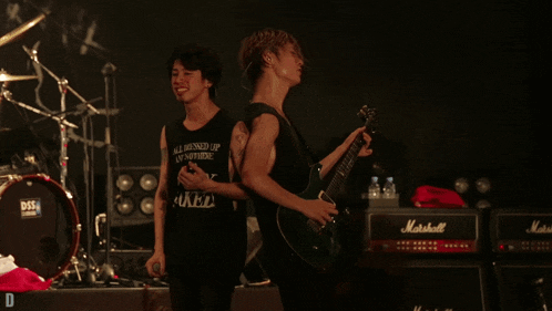 a man in a black tank top that says all messed up