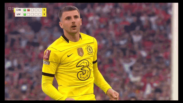 a soccer player in a yellow shirt with the number 3 on it