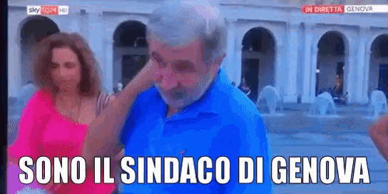 a man in a blue shirt is being interviewed by a woman with the words sono il sindaco di genova written below him