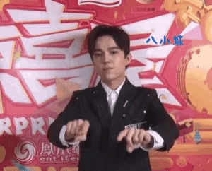 a man in a suit and tie is dancing in front of a sign that says app