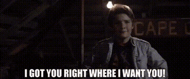 a man is standing in front of a cafe and says `` i got you right where i want you '' .