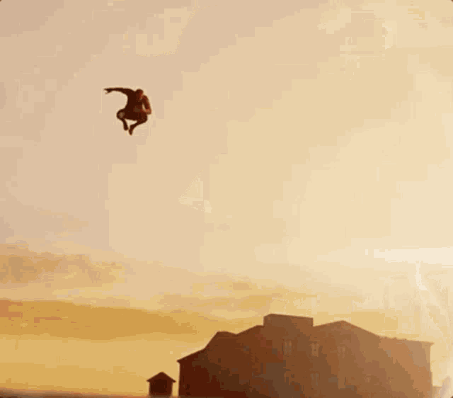 a blurry picture of a man in a spiderman costume standing on a rock .