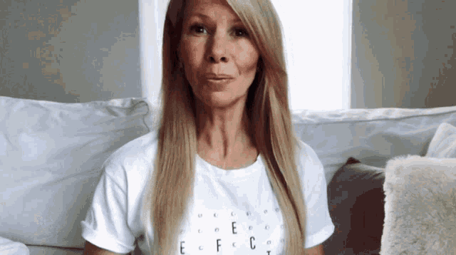 a woman wearing a white t-shirt that says effect on it