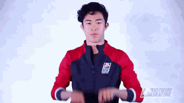 a man wearing a red and blue jacket with the word us figure skating on it