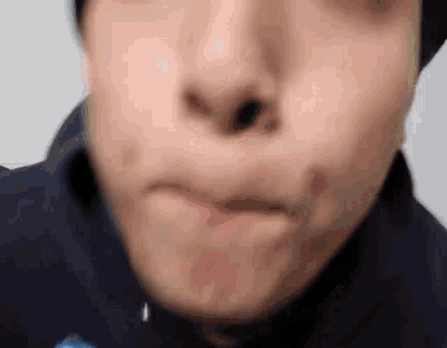 a close up of a man making a funny face with his mouth open and his nose sticking out .