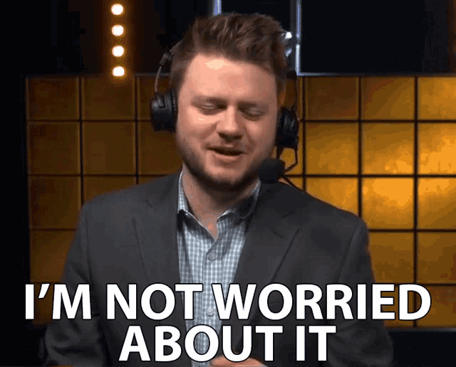 a man wearing a suit and headphones says i 'm not worried about it