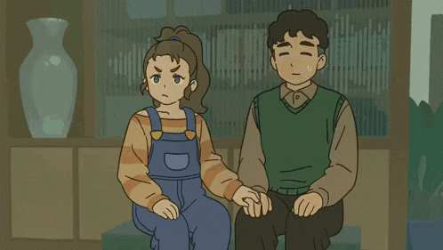 a man and woman are sitting on a couch in a living room