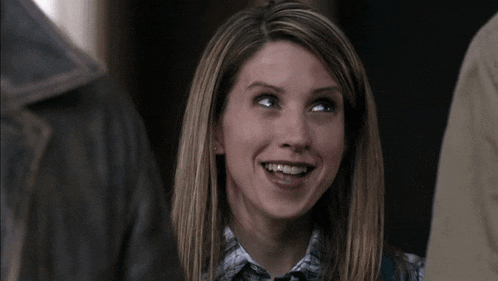 a woman with blonde hair is smiling and looking up at something