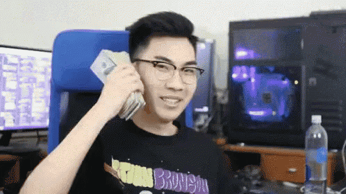 a man with glasses is holding a bunch of money in his hand