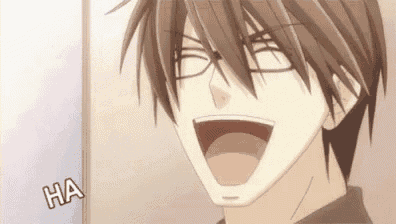 a close up of a man with glasses laughing .
