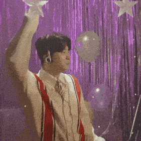 a man wearing headphones is holding a star in his hand
