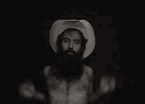 a man with a beard wearing a cowboy hat