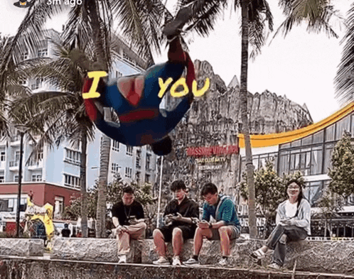 a man in a superhero costume is hanging upside down with the word i you written on his chest