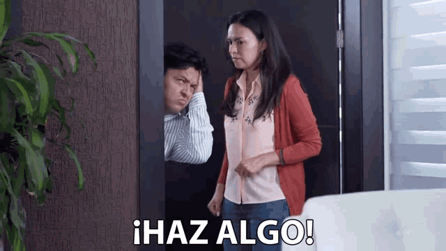 a woman standing next to a man with the words haz algo written above her