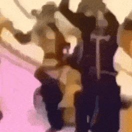 a blurry picture of a person holding a sword in their hands .