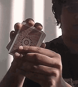a man is holding a card with a sun on it