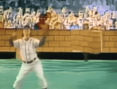 a baseball player throws a ball in front of a crowd