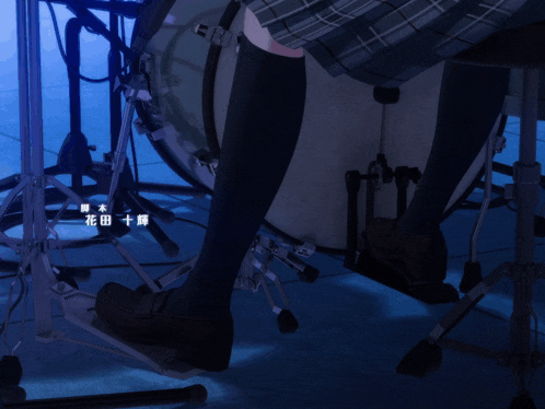 a person playing a drum set with chinese writing on the floor