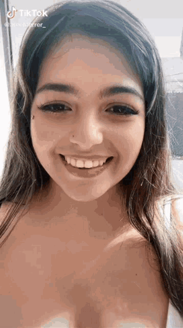 a close up of a woman 's face with a tik tok watermark