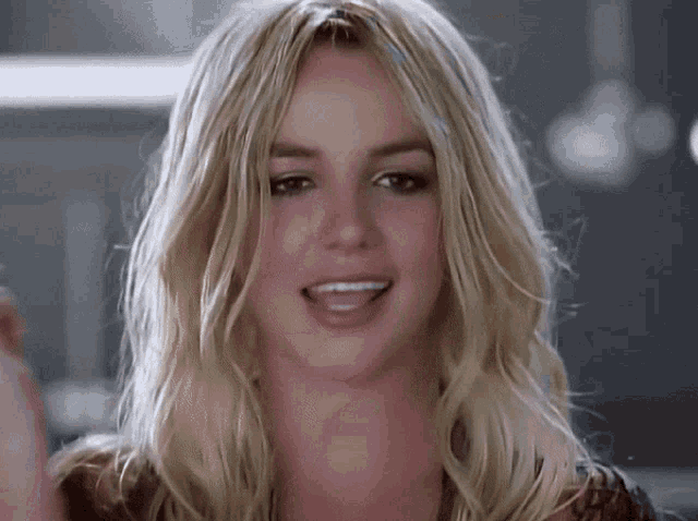 a close up of a woman 's face with her mouth open