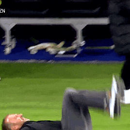a man is laying on his stomach on a soccer field