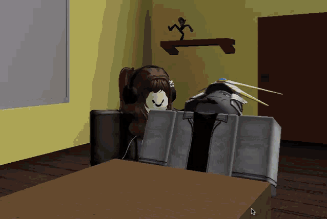 a girl wearing headphones is sitting at a table