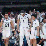 a group of basketball players with one wearing a number 21 jersey