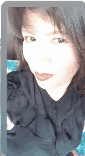 a close up of a woman 's face with a black shirt on