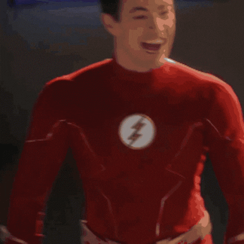 a man in a red suit stands in front of a display
