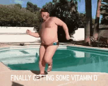 a shirtless man in swim trunks is jumping into a swimming pool with the words finally getting some vitamin d below him