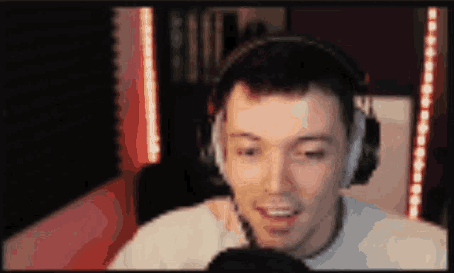 a blurry picture of a man wearing headphones talking into a microphone