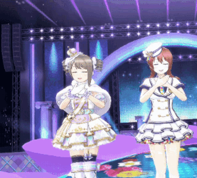 two anime girls stand on a stage with their hands folded