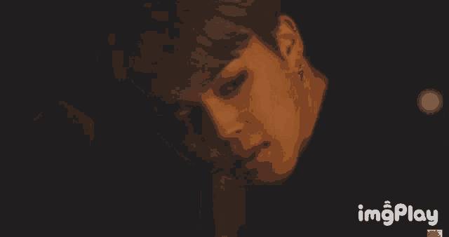 a close up of a person 's face with the words imgplay on the bottom right