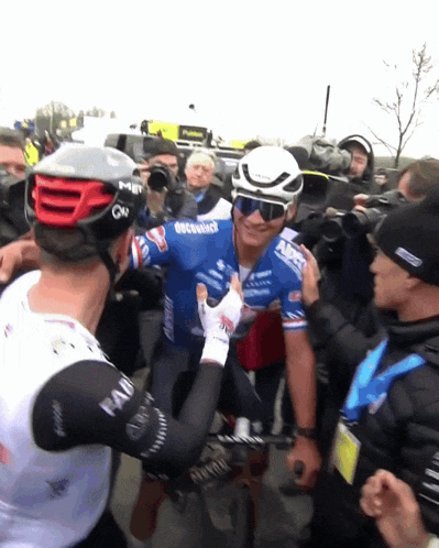 a man wearing a helmet that says msr on it is being held by another man