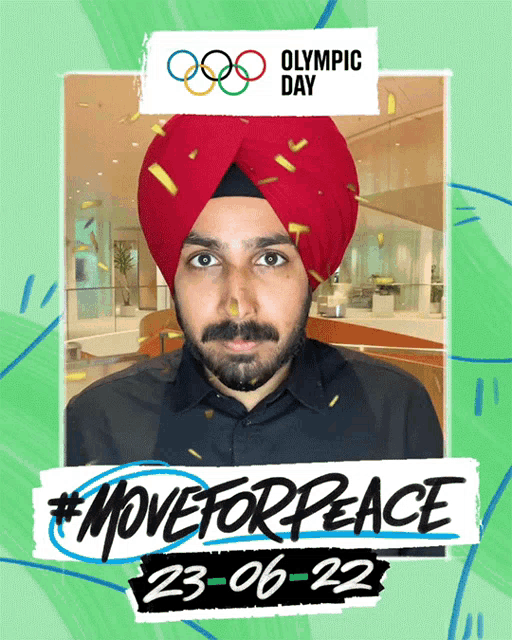 a man wearing a red turban stands in front of a sign that says " olympic day "