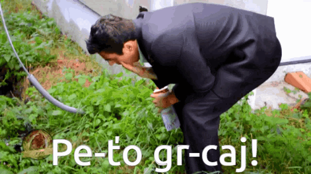 a man in a suit is kneeling down in the grass with the words pe-to gr-caj written on the bottom