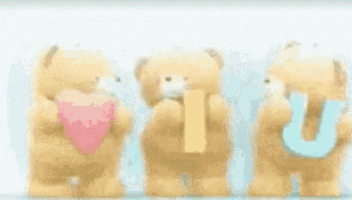 two teddy bears are standing next to each other holding a letter u