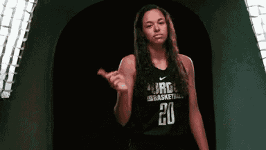 a female basketball player wearing a black jersey with the number 20 on it