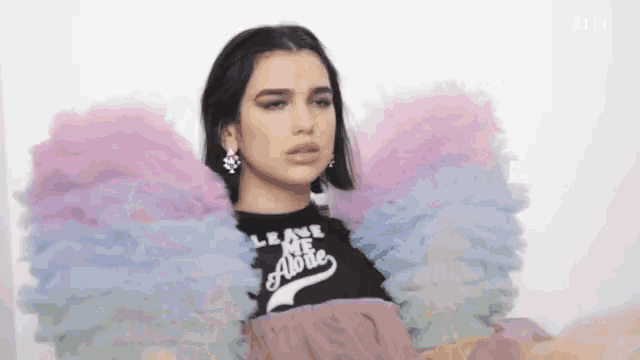 a woman wearing a black shirt that says leave me alone on it