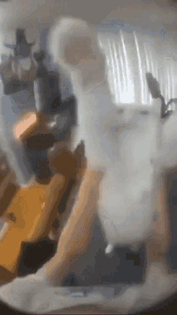 a person is holding a stuffed animal in their hands in a living room