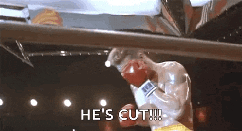 a man is boxing in a ring with the words `` he 's cut '' written on the screen .